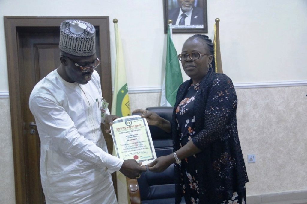 Award presentation on Ethics from the Executive Director of the center for Ethics and Self Value Orientation, Prince Salih Musa Yakubu to the Deputy Vice-Chancellor Administration and Development, Professor Mrs. Janet Olaitan.