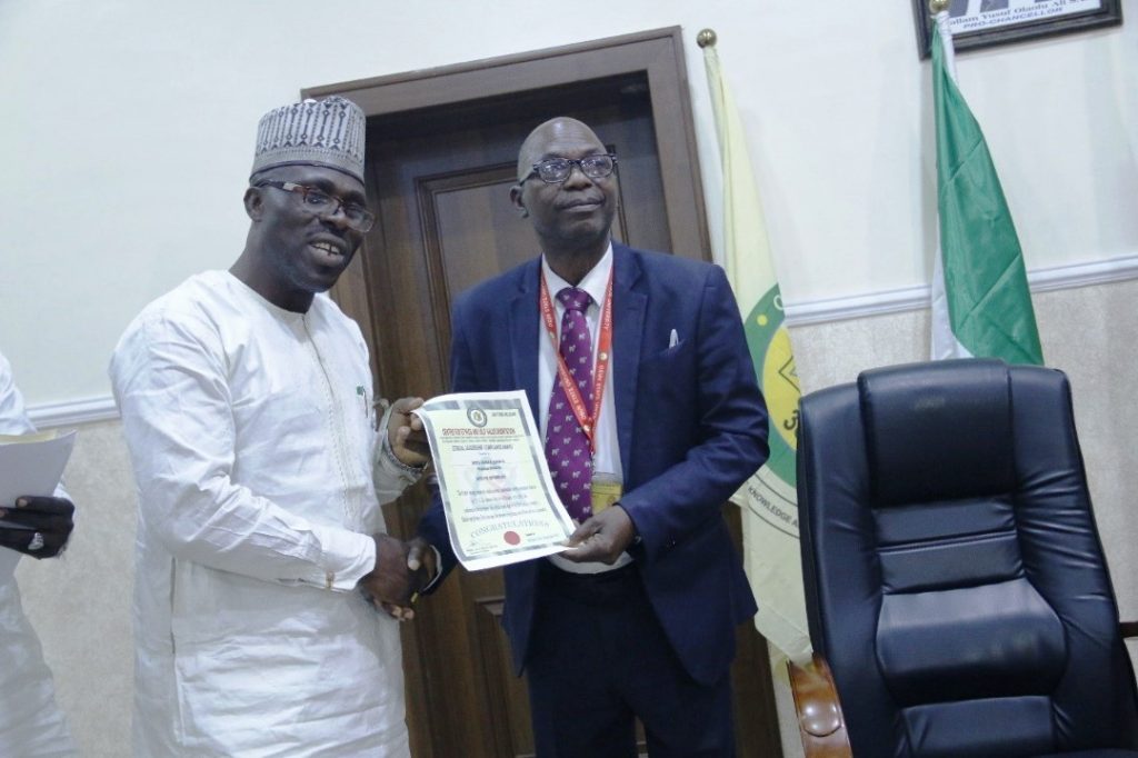 Award presentation on Ethics from the Executive Director of the center for Ethics and Self Value Orientation, Prince Salih Musa Yakubu to the University Registrar, Mr. Gafar Shittu.