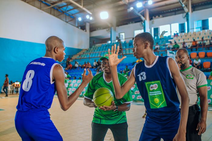 Category Manager for Beverages, Nestlé Nigeria, Mr. Olutayo Olatunji (middle) performing the ceremonial jump-ball at the start of the game between Urhobo Model College Effurun Delta State and Bishop Dimieari Grammar School Ovom Bayelsa State at the Indoor Sports Hall of the Stephen Keshi Stadium Asaba recently.