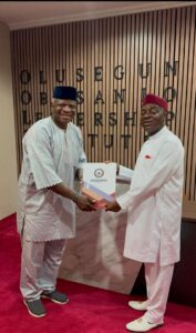 From left: Prof. Samuel Daramola, Deputy Chief Executive, Olusegun Obasanjo Leadership Institute (OOLI), presents a souvenir to Bishop David O. Oyedepo, Founder and Presiding Bishop of Living Faith Church Worldwide and Chancellor of Covenant University.